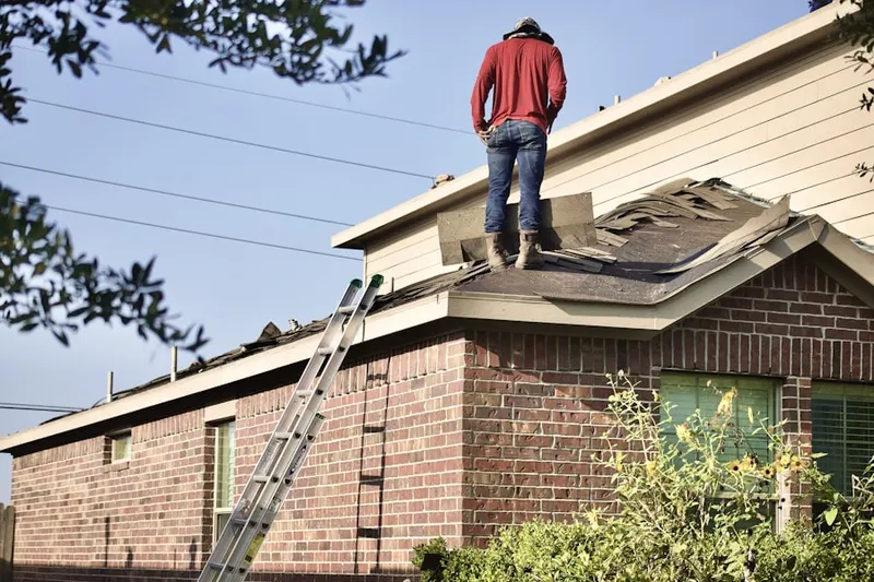 Professional roofer working on a residential roof in Coppei